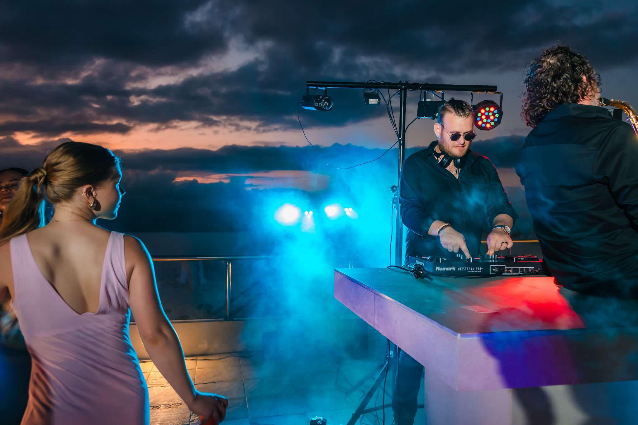 Whitsunday Entertainment Wedding DJ - Daniel Ahri playing rooftop set at dusk.